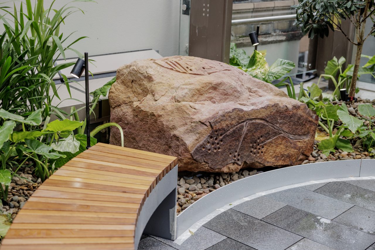 Photo of a sandstone boulder featuring Jamie Eastwood's rock carvings
